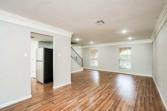 unfurnished room with light wood-type flooring and ornamental molding