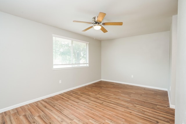 empty room with ceiling fan and light wood-type flooring