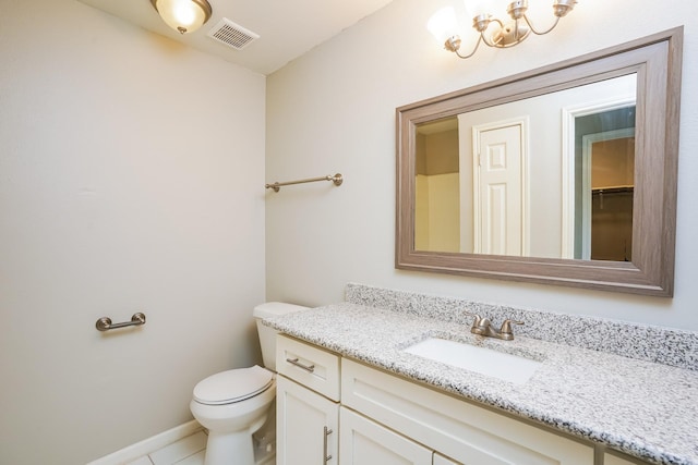 bathroom with toilet, tile patterned flooring, and vanity