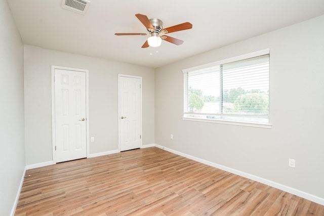 unfurnished bedroom with ceiling fan and light hardwood / wood-style flooring