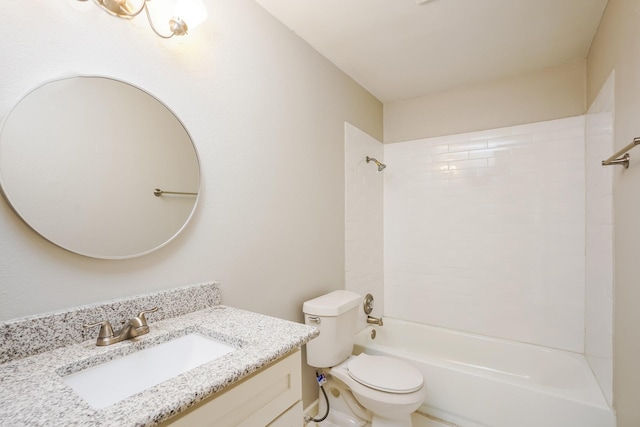 full bathroom with toilet, vanity, and tiled shower / bath