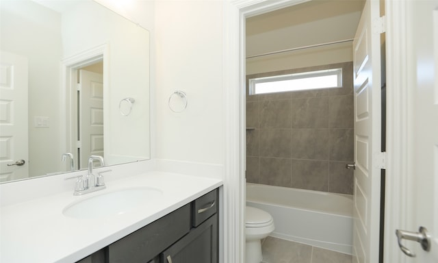 full bathroom featuring tile patterned floors, vanity, toilet, and tiled shower / bath