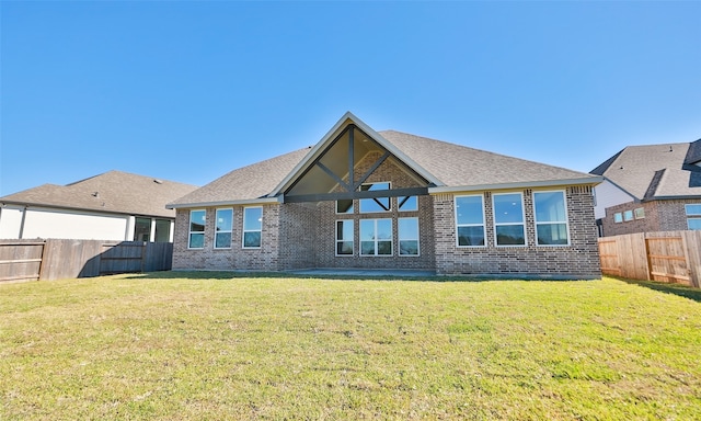 rear view of property featuring a yard