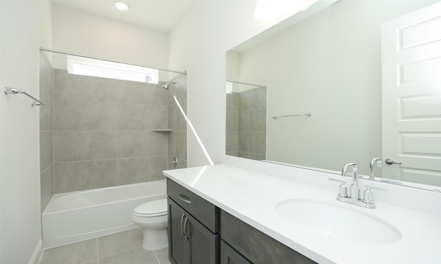 full bathroom featuring tile patterned flooring, vanity, toilet, and tiled shower / bath combo