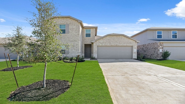 view of front of home with a garage and a front lawn