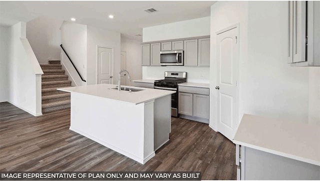 kitchen with gray cabinets, a kitchen island with sink, sink, and appliances with stainless steel finishes