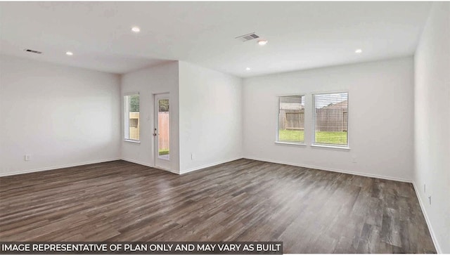 spare room featuring dark hardwood / wood-style floors