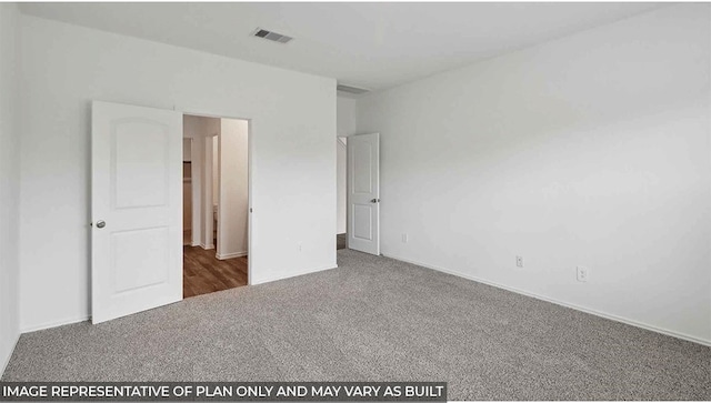 unfurnished bedroom featuring dark carpet