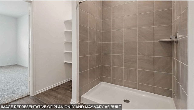 bathroom featuring tiled shower and hardwood / wood-style floors