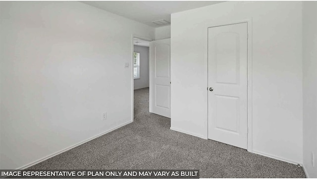 unfurnished bedroom with dark colored carpet