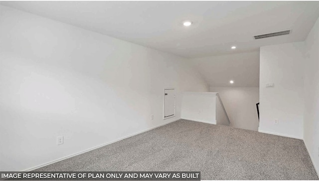 empty room with carpet floors and lofted ceiling