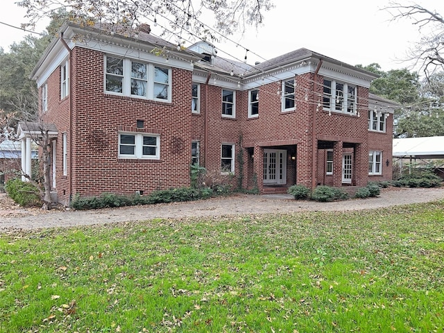 rear view of property with a yard