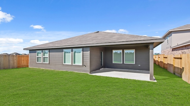 rear view of property featuring a yard and a patio