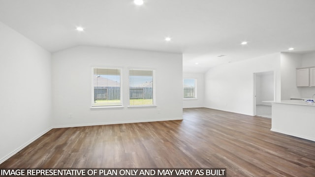 unfurnished living room featuring hardwood / wood-style floors and lofted ceiling