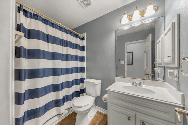 bathroom with tile patterned flooring, vanity, a textured ceiling, a shower with curtain, and toilet