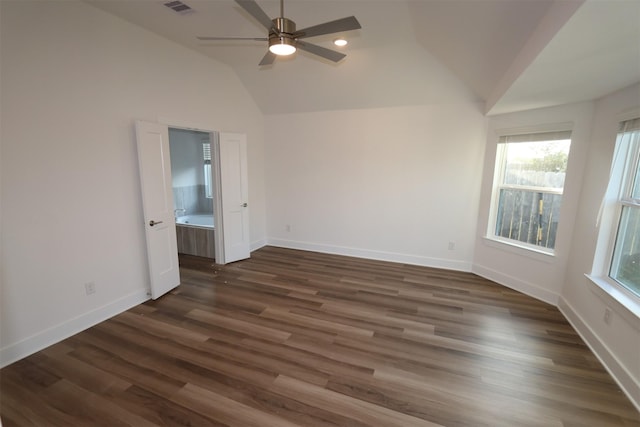 spare room featuring ceiling fan, dark wood-type flooring, and vaulted ceiling