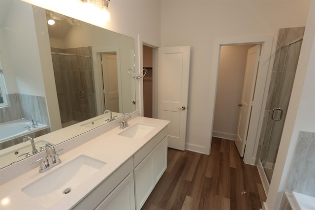 bathroom featuring vanity, hardwood / wood-style flooring, and separate shower and tub