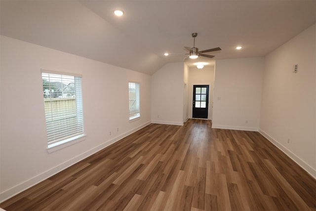 interior space with lofted ceiling, dark wood-type flooring, ceiling fan, and a healthy amount of sunlight