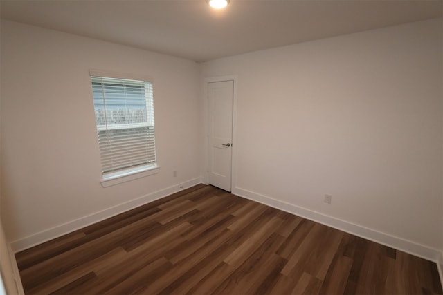 spare room with dark hardwood / wood-style flooring