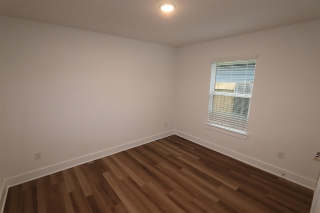 spare room featuring dark hardwood / wood-style flooring