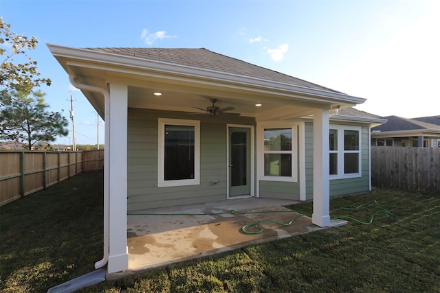 rear view of house with a lawn, ceiling fan, and a patio