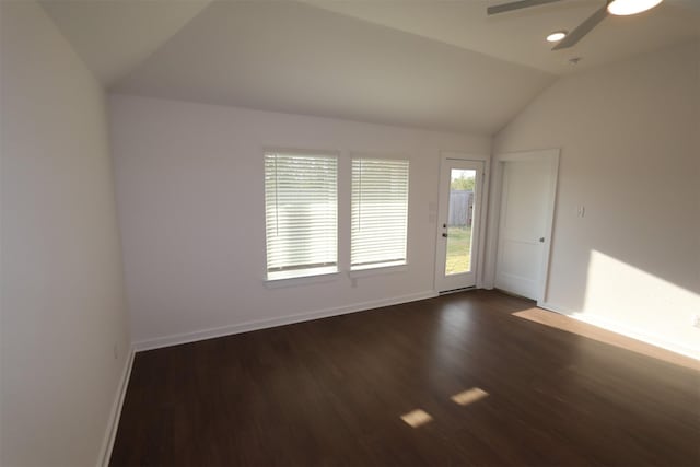 empty room featuring ceiling fan, dark hardwood / wood-style flooring, and lofted ceiling