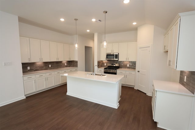 kitchen featuring white cabinetry, sink, dark hardwood / wood-style flooring, backsplash, and appliances with stainless steel finishes