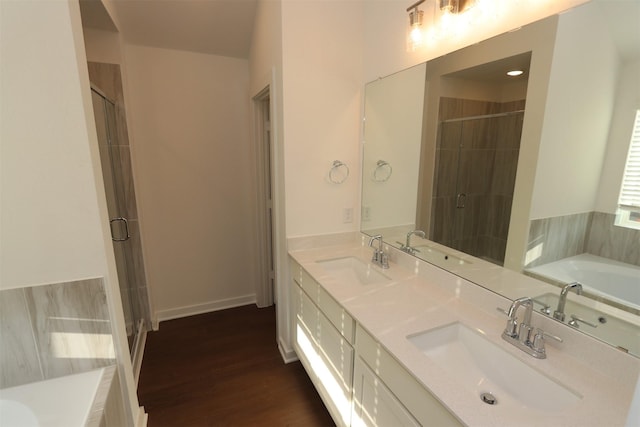 bathroom with vanity, wood-type flooring, and shower with separate bathtub