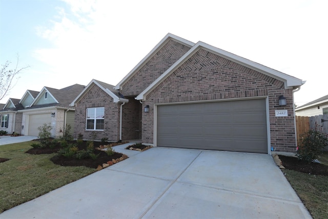 view of front of property featuring a garage and a front lawn