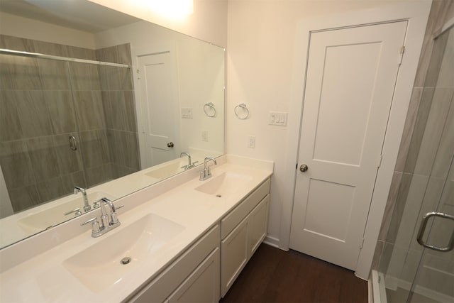 bathroom with vanity, wood-type flooring, and an enclosed shower