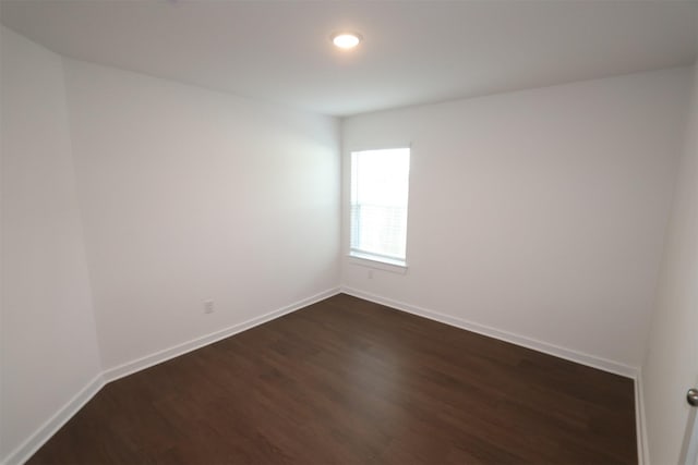 empty room featuring dark wood-type flooring