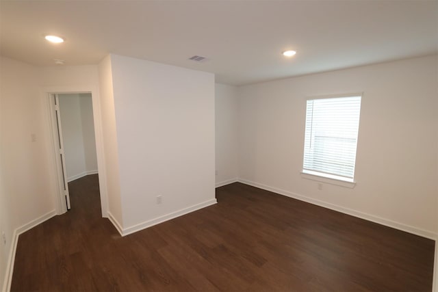 empty room featuring dark hardwood / wood-style flooring