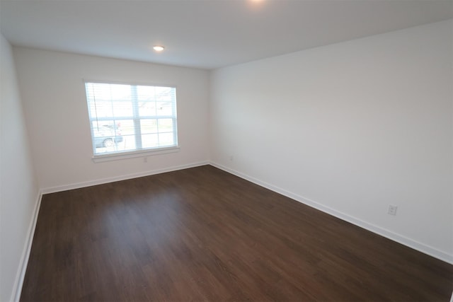 spare room featuring dark hardwood / wood-style flooring