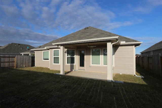 rear view of property with a lawn, ceiling fan, and a patio