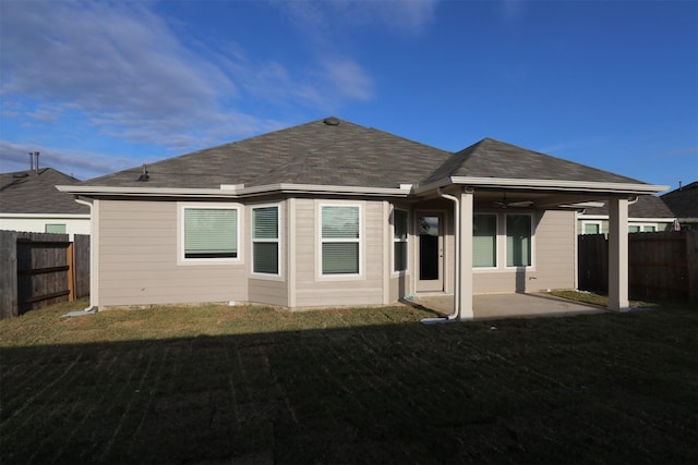 back of property featuring a yard, ceiling fan, and a patio area