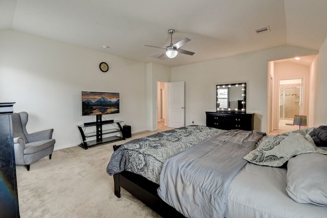 carpeted bedroom with connected bathroom, vaulted ceiling, and ceiling fan