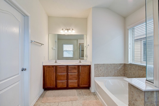 bathroom with vanity, vaulted ceiling, plus walk in shower, and tile patterned floors