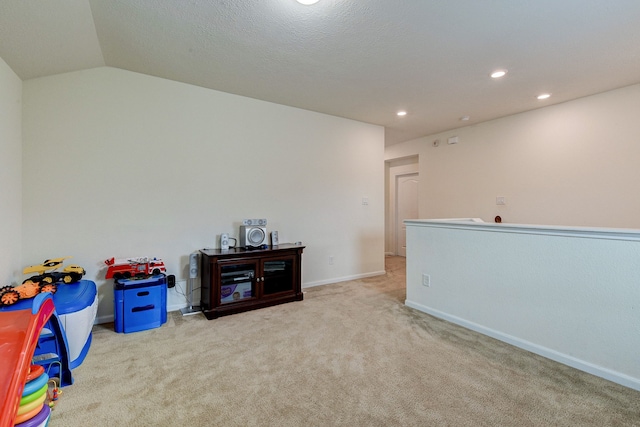 playroom featuring light carpet and lofted ceiling