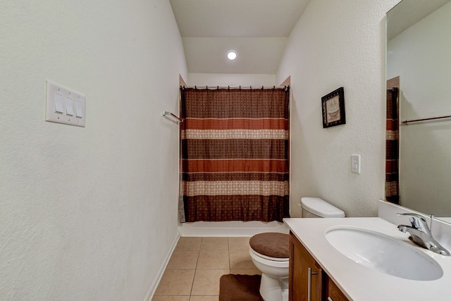 bathroom with tile patterned flooring, walk in shower, vanity, and toilet