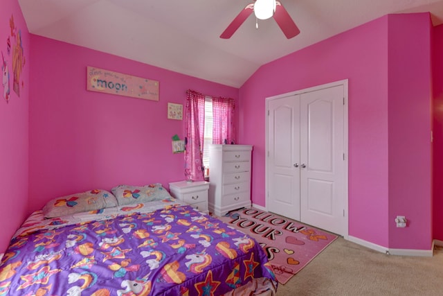 carpeted bedroom with a closet, vaulted ceiling, and ceiling fan