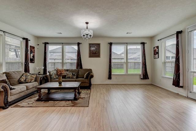 living room featuring light wood-type flooring and plenty of natural light