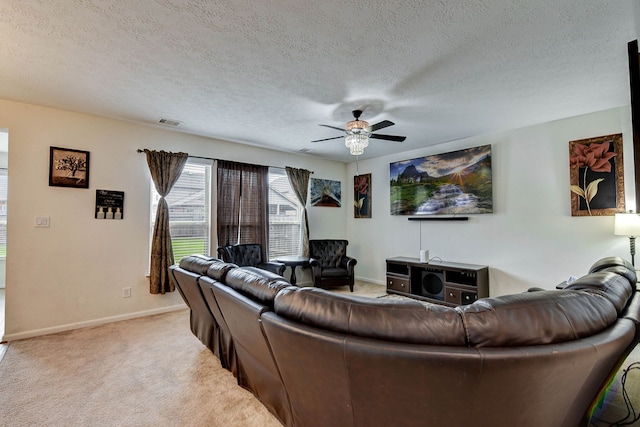 carpeted living room featuring a textured ceiling and ceiling fan