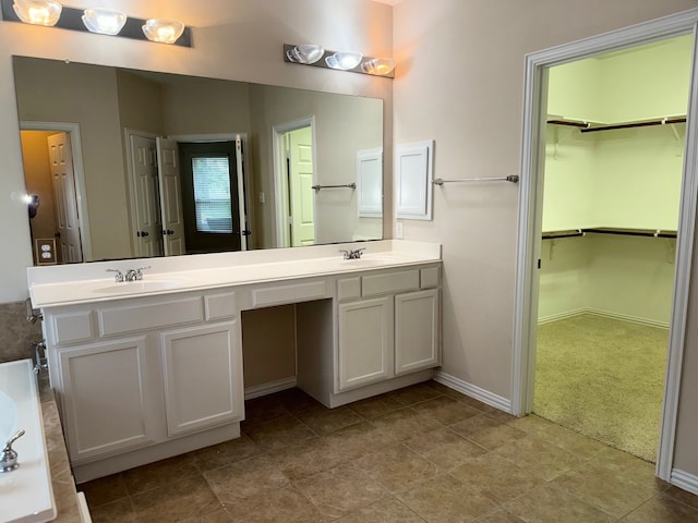 bathroom with a bathing tub, tile patterned floors, and double sink vanity