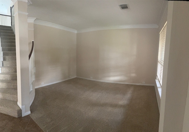 carpeted empty room with ornate columns and crown molding