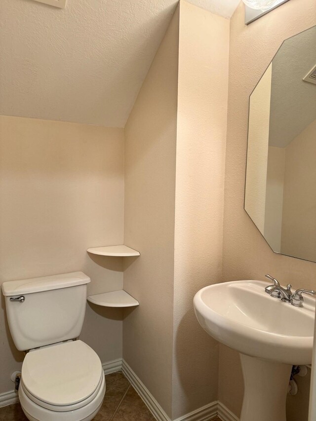 bathroom with tile patterned floors and toilet