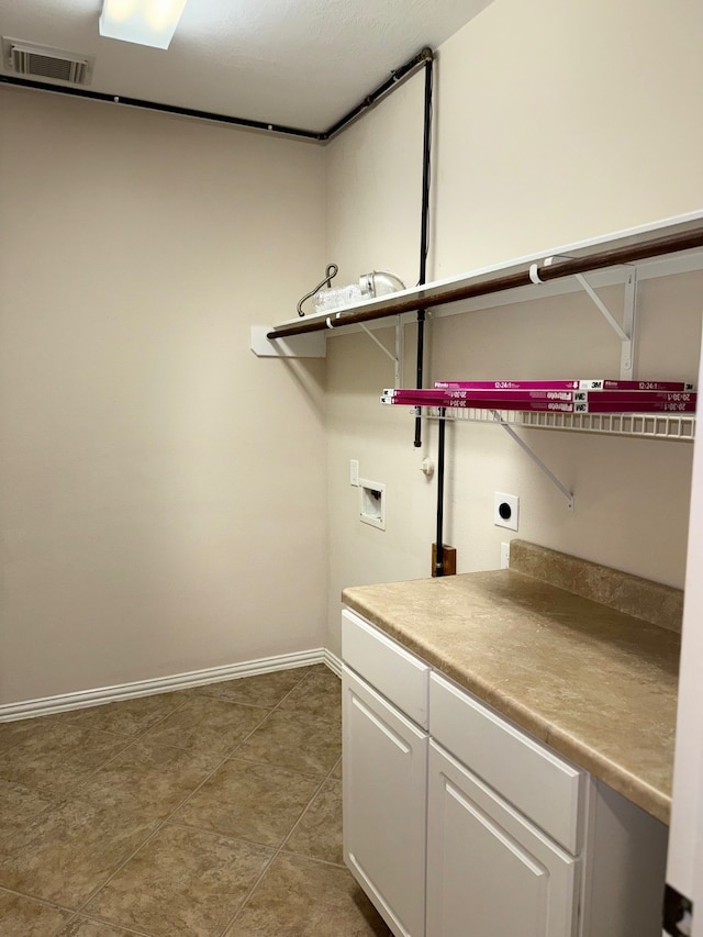 washroom featuring cabinets, tile patterned floors, hookup for an electric dryer, and hookup for a washing machine