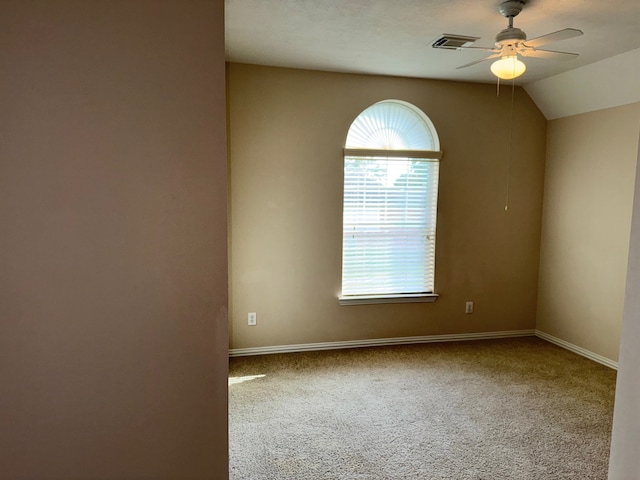 carpeted empty room featuring ceiling fan and lofted ceiling