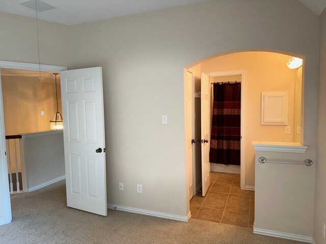 unfurnished bedroom with carpet and a walk in closet