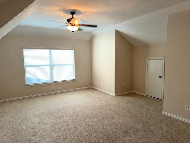 bonus room with a textured ceiling, carpet flooring, lofted ceiling, and ceiling fan