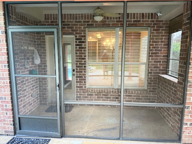 view of exterior entry with ceiling fan